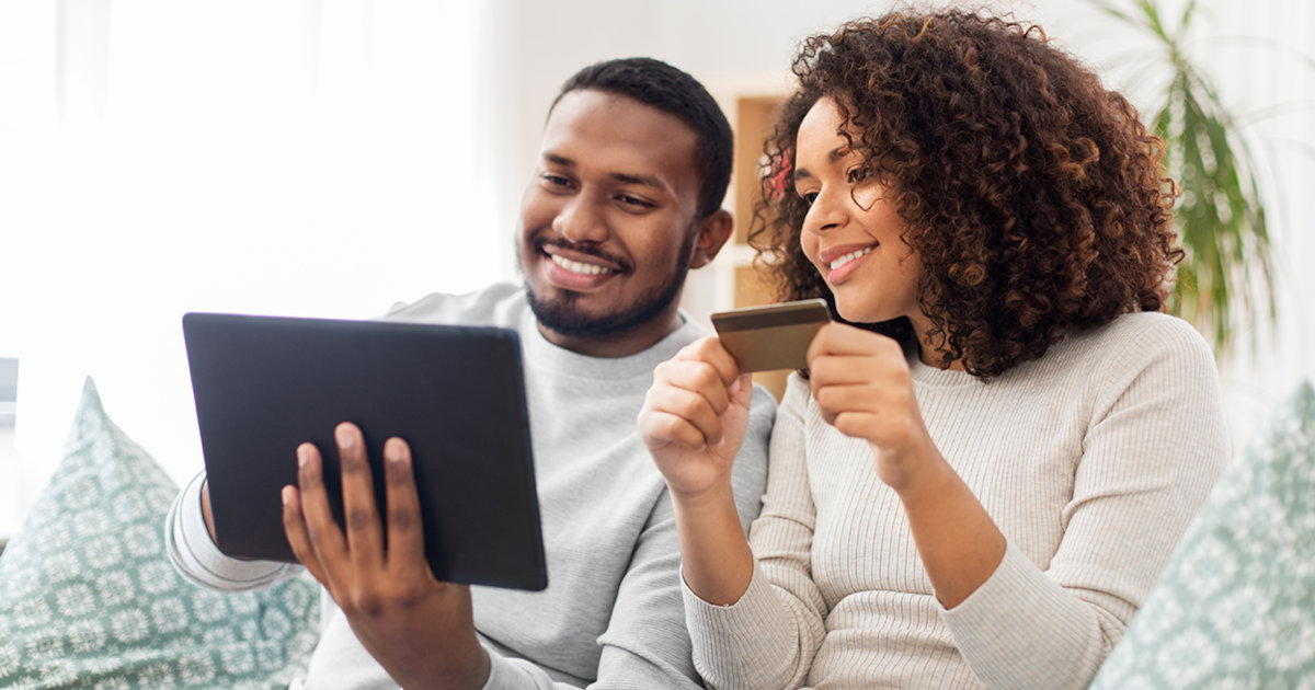 couple paying on tablet